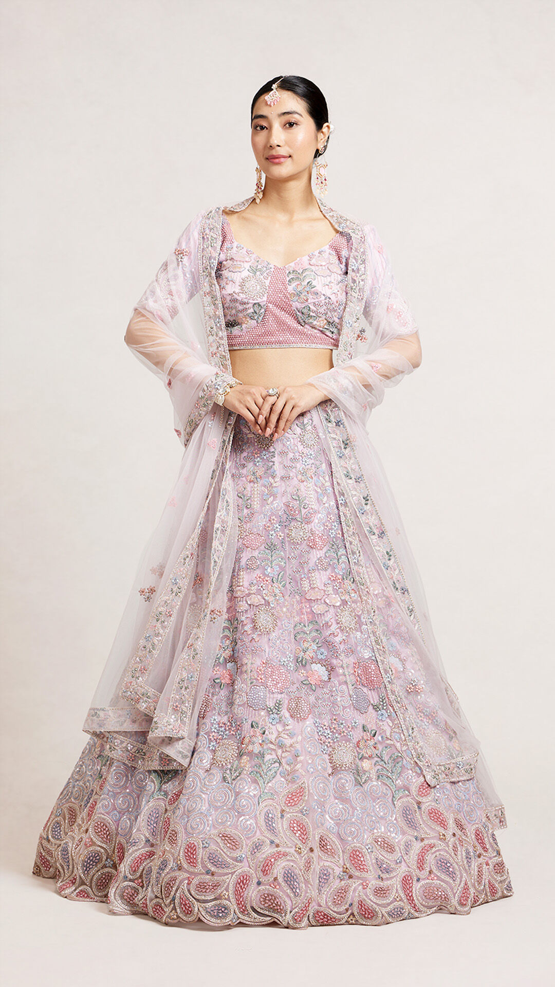 A bride in beautifull pink bridal lehenga with pink dupatta on it 